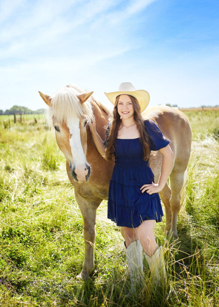 Senior Girl Posing with Her Horse in Navy Dress