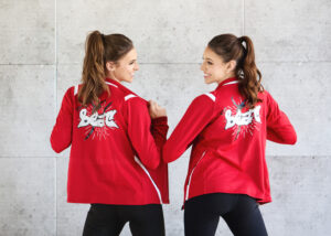 two sisters in red dance jackets