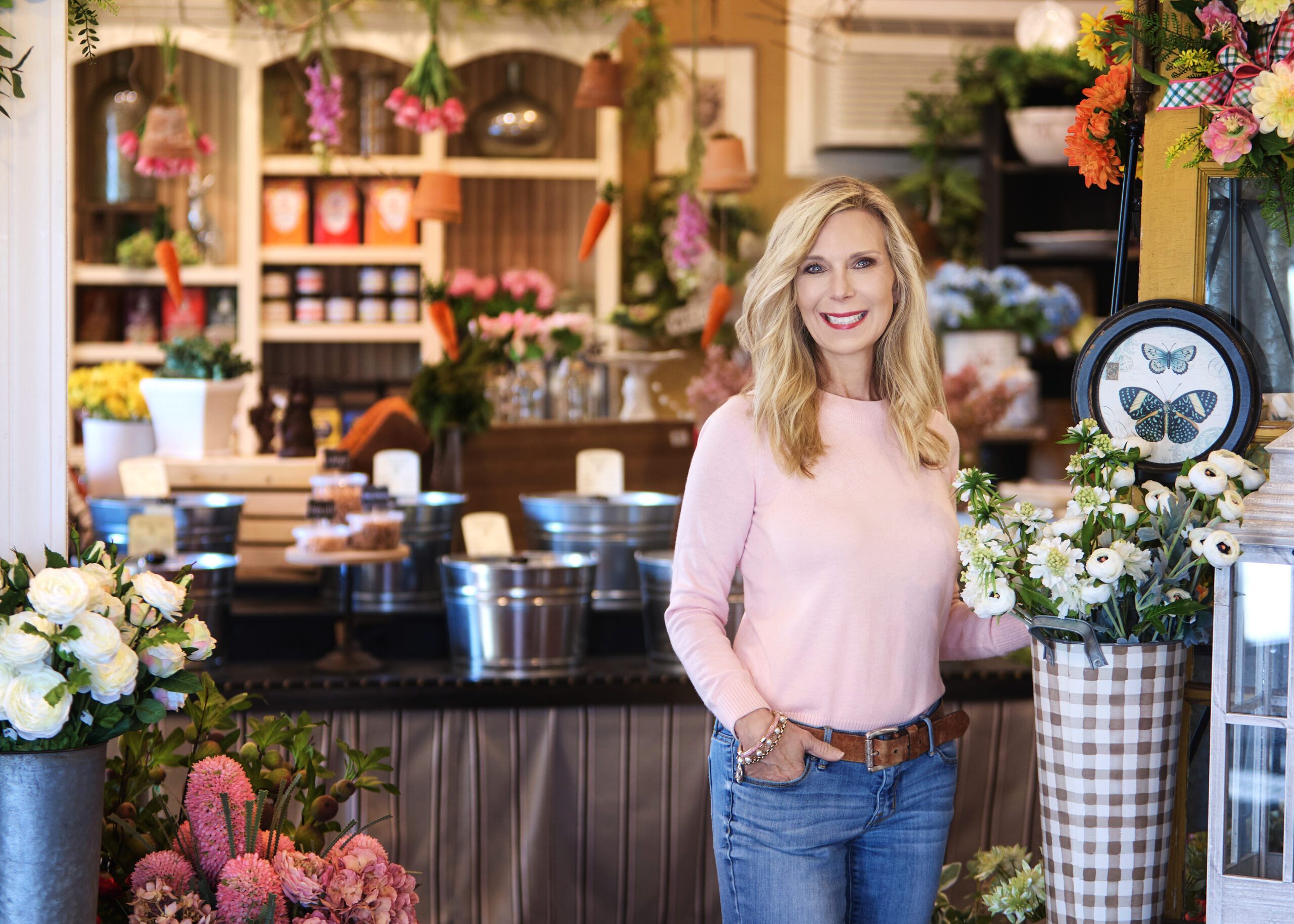 woman in pink sweater in a floral shop