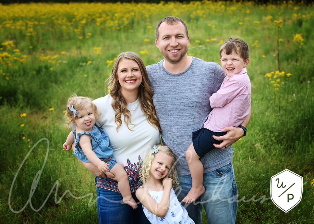 family of 5 in a field of yellow wildflowers