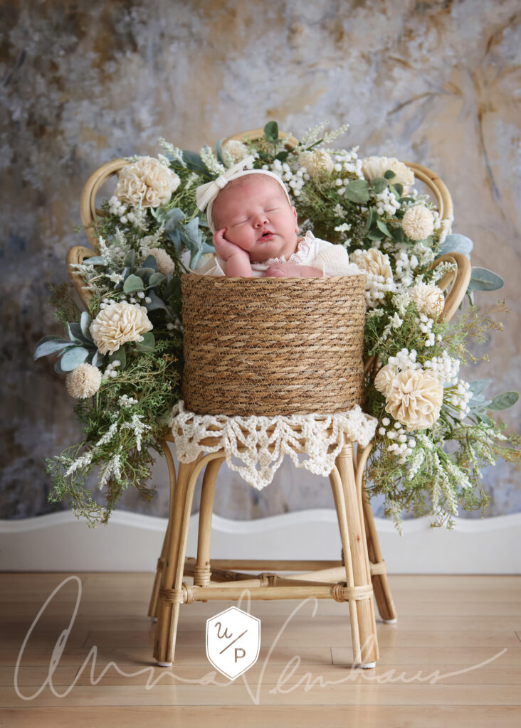 Baby in basket surrounded by florals